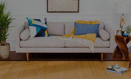 Yellow Natural Bamboo Area Rug and a white sofa with blue and yellow throw pillows