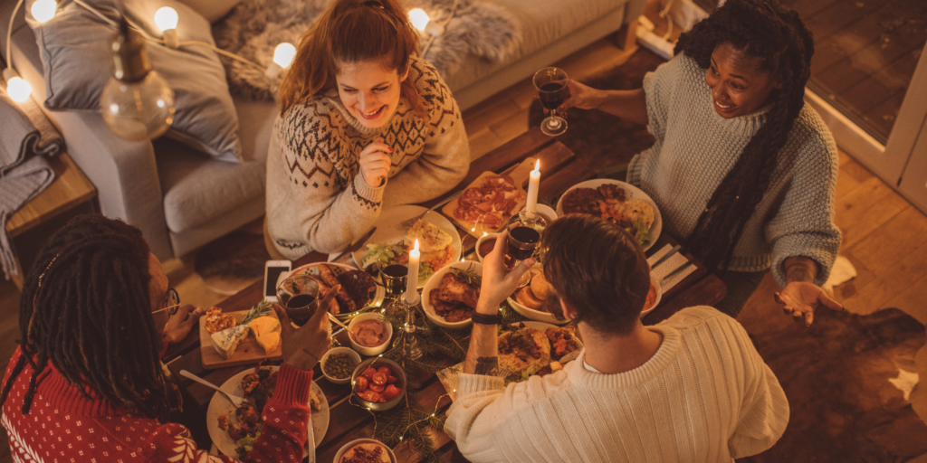 a group of 4 people gathering around a cozy dinner and having a conversation