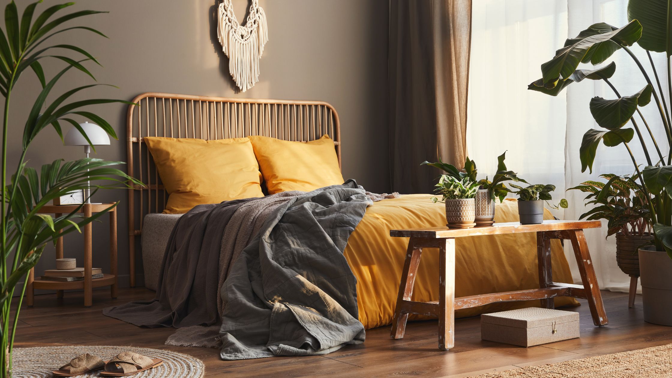 maximalist bedroom featuring warm colors, plants and dark wall