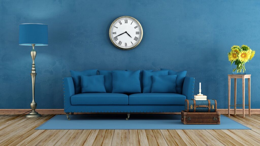 A blue couch with colorful decor