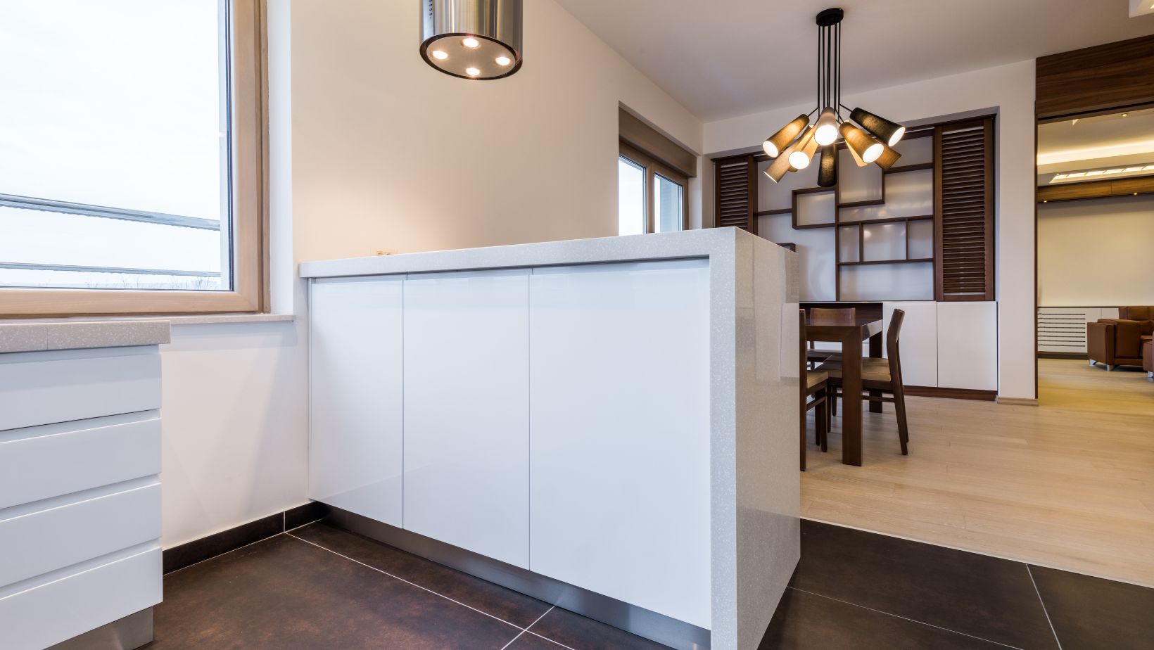 A white kitchen island with a waterfall edge